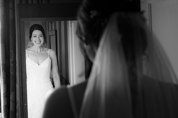 Bride looking in mirror.