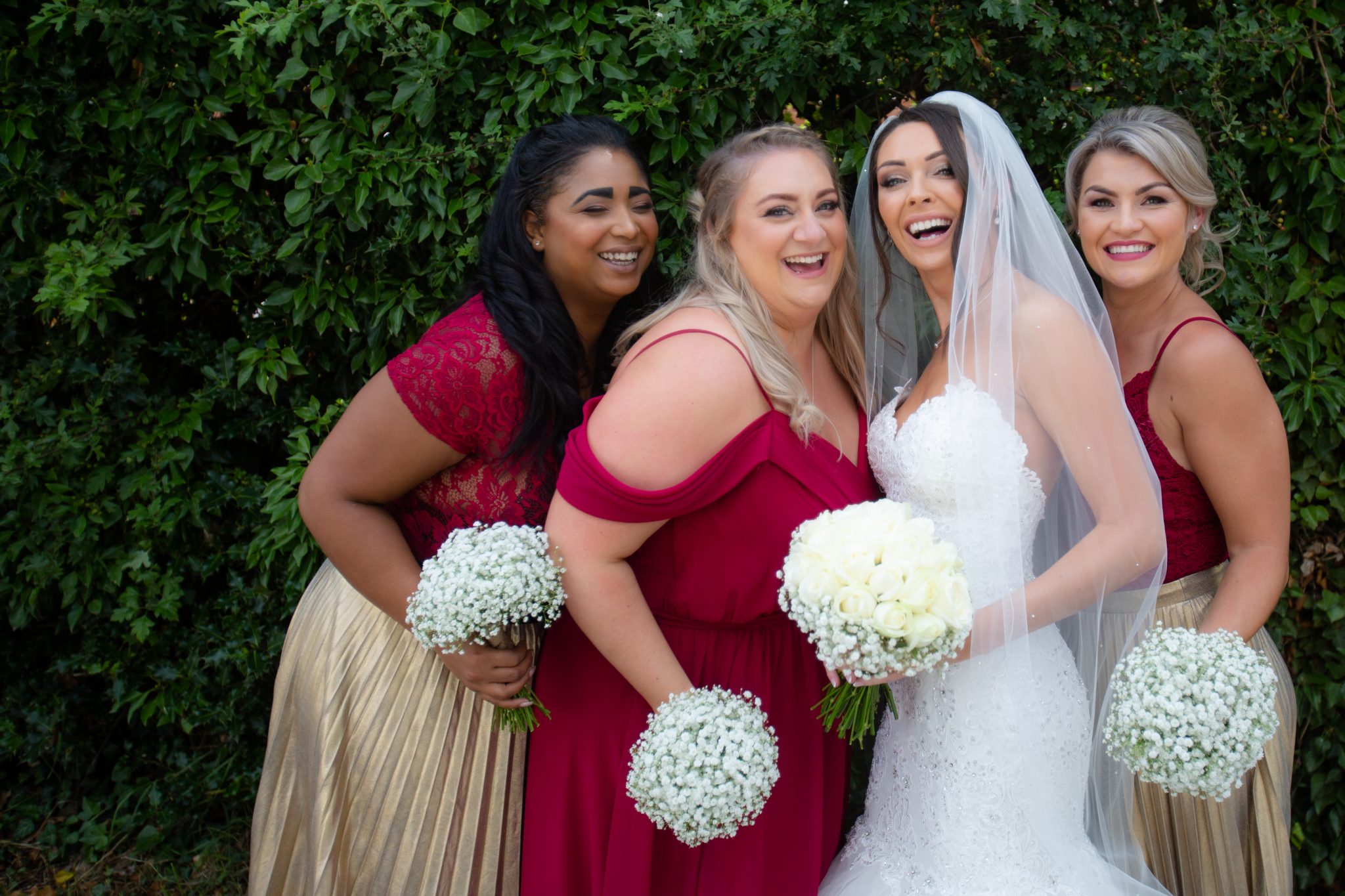 Bride and Bridesmaids laughing.