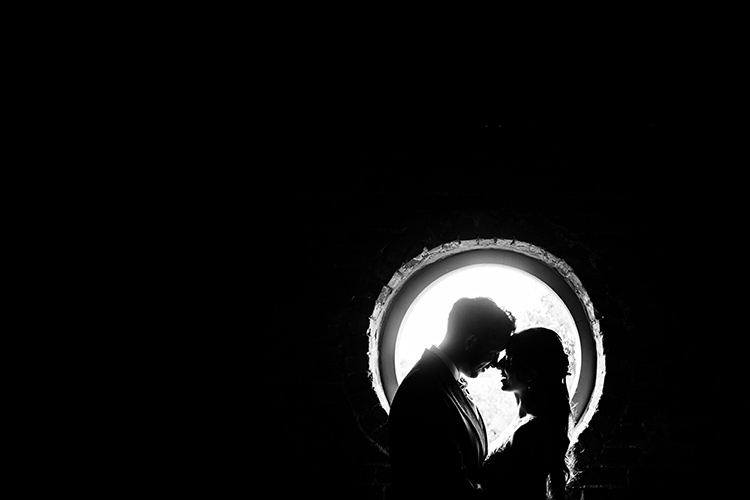Bride and Groom silhouetted in window.